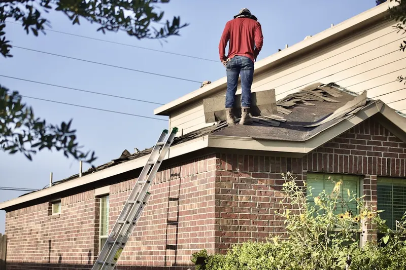 Professional roofer working on a residential roof in Harbor Oaks